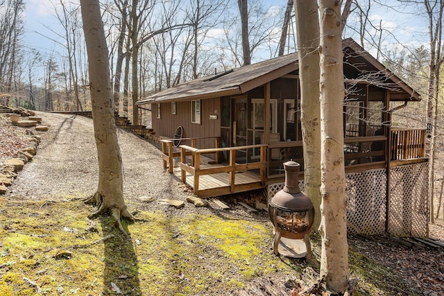 exterior space featuring a sunroom and a wooden deck