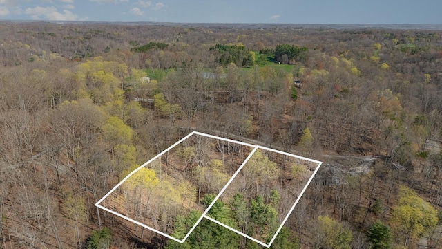drone / aerial view featuring a forest view