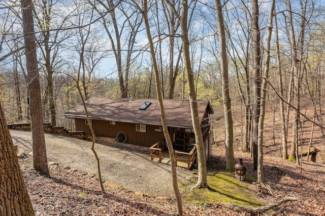 back of property with roof with shingles