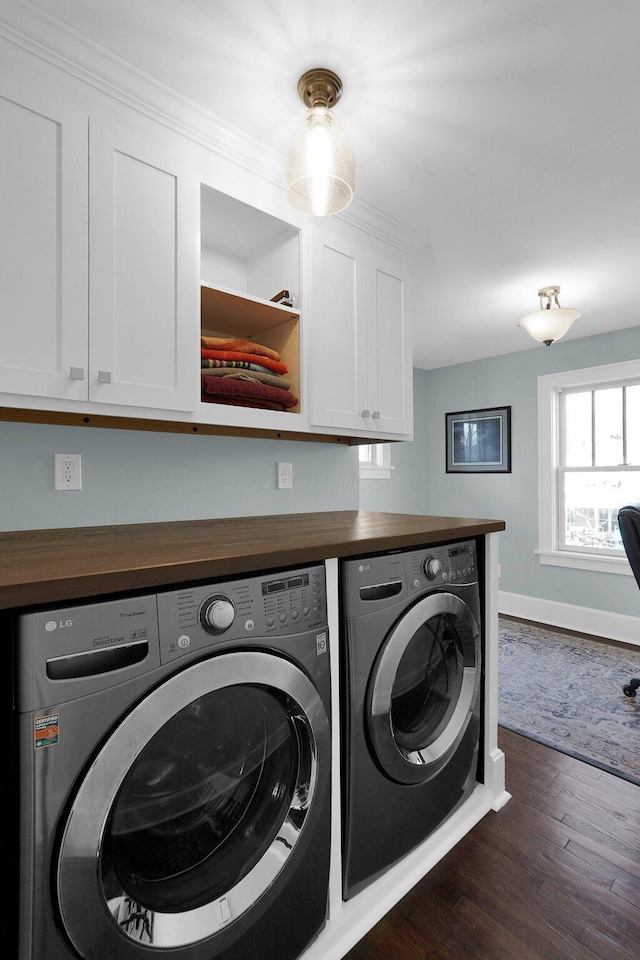 78 N Burgess Ave, Columbus, OH 43204 - washroom with dark wood-style flooring, baseboards, cabinet space, and washing machine and dryer