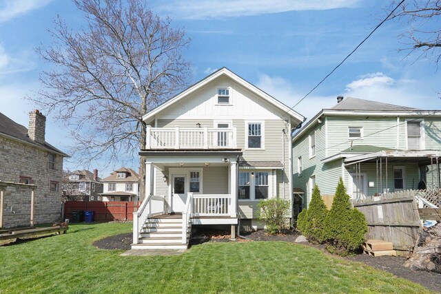 78 N Burgess Ave, Columbus, OH 43204 - back of property with board and batten siding, a lawn, a porch, fence, and a balcony