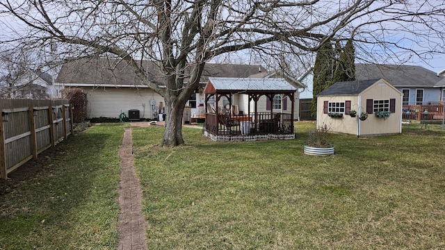 620 Lewis St, Washington Court House, OH 43160 - view of yard featuring a gazebo, a fenced backyard, a storage unit, central air condition unit, and an outbuilding