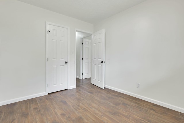 empty room with wood finished floors and baseboards