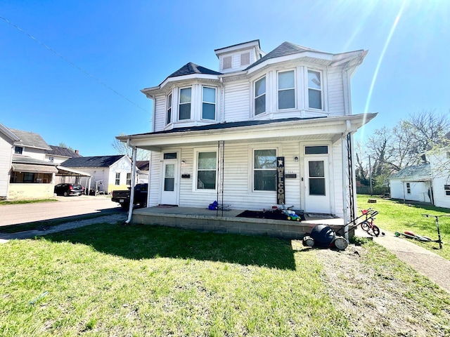 view of front of house with a front yard and a porch