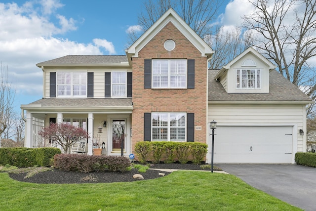 6690 Hermitage Dr, Westerville, OH 43082 - traditional-style home with a shingled roof, a front lawn, an attached garage, driveway, and brick siding
