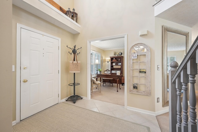 6690 Hermitage Dr, Westerville, OH 43082 - foyer entrance with light colored carpet, a towering ceiling, baseboards, and light tile patterned floors