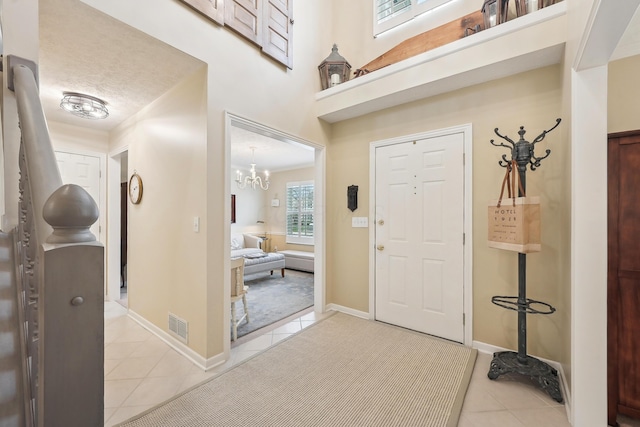 6690 Hermitage Dr, Westerville, OH 43082 - foyer entrance featuring baseboards, visible vents, a notable chandelier, and light tile patterned flooring