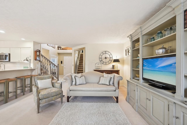 6690 Hermitage Dr, Westerville, OH 43082 - living area featuring stairway, a textured ceiling, light colored carpet, and recessed lighting