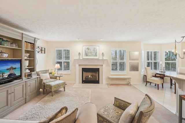 6690 Hermitage Dr, Westerville, OH 43082 - living area with an inviting chandelier, baseboards, a fireplace, and a textured ceiling