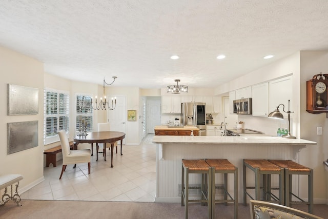 6690 Hermitage Dr, Westerville, OH 43082 - kitchen with baseboards, a chandelier, and stainless steel appliances