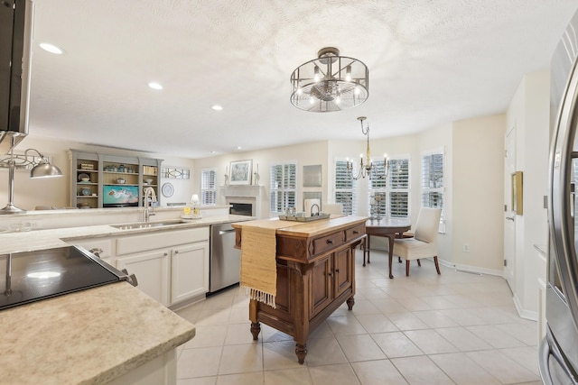 6690 Hermitage Dr, Westerville, OH 43082 - kitchen with recessed lighting, stainless steel appliances, a sink, and a chandelier