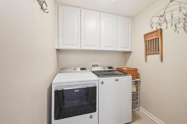 6690 Hermitage Dr, Westerville, OH 43082 - washroom featuring washing machine and dryer, baseboards, light tile patterned flooring, and cabinet space