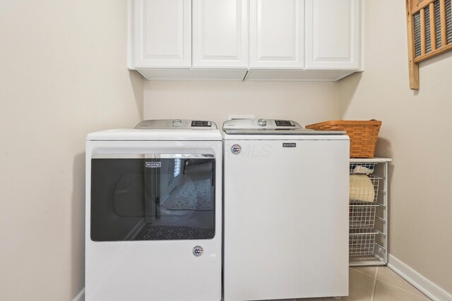 6690 Hermitage Dr, Westerville, OH 43082 - laundry room with baseboards, washer and dryer, light tile patterned floors, and cabinet space