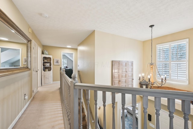 6690 Hermitage Dr, Westerville, OH 43082 - corridor featuring an upstairs landing, an inviting chandelier, light colored carpet, baseboards, and recessed lighting