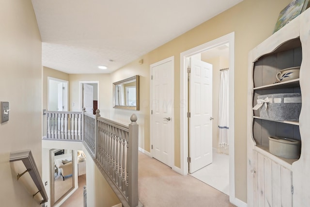 6690 Hermitage Dr, Westerville, OH 43082 - hallway featuring baseboards, light colored carpet, and an upstairs landing