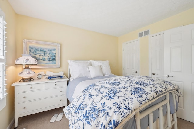 6690 Hermitage Dr, Westerville, OH 43082 - bedroom with dark colored carpet, multiple windows, and visible vents