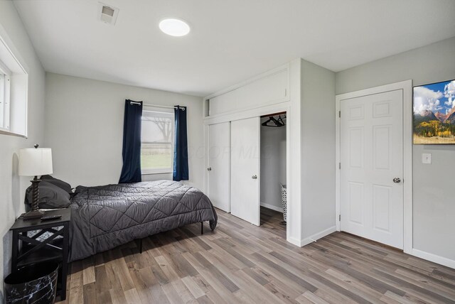 1779 Fairwood Ave, Columbus, OH 43207 - bedroom with a closet, baseboards, light wood finished floors, and visible vents