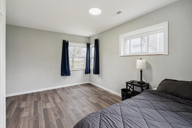 1779 Fairwood Ave, Columbus, OH 43207 - bedroom featuring wood finished floors, baseboards, and visible vents