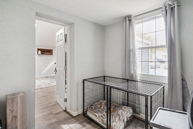 1779 Fairwood Ave, Columbus, OH 43207 - hall featuring wood finished floors, a textured wall, and baseboards