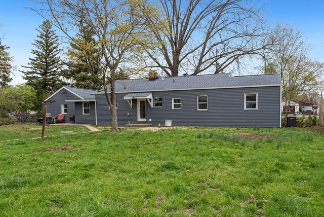 1779 Fairwood Ave, Columbus, OH 43207 - back of property with fence, a yard, central AC, and a chimney