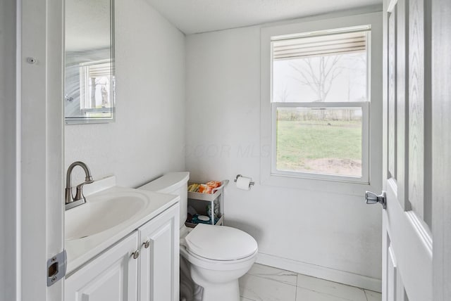 1779 Fairwood Ave, Columbus, OH 43207 - bathroom featuring toilet, marble finish floor, vanity, and a healthy amount of sunlight
