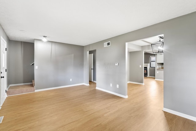 121 Granville St, Pataskala, OH 43062 - unfurnished room featuring light wood-type flooring, an inviting chandelier, baseboards, and visible vents