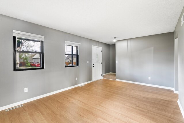 121 Granville St, Pataskala, OH 43062 - empty room with visible vents, light wood-style flooring, and baseboards