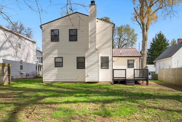 121 Granville St, Pataskala, OH 43062 - rear view of property with metal roof, a lawn, a chimney, fence, and a wooden deck