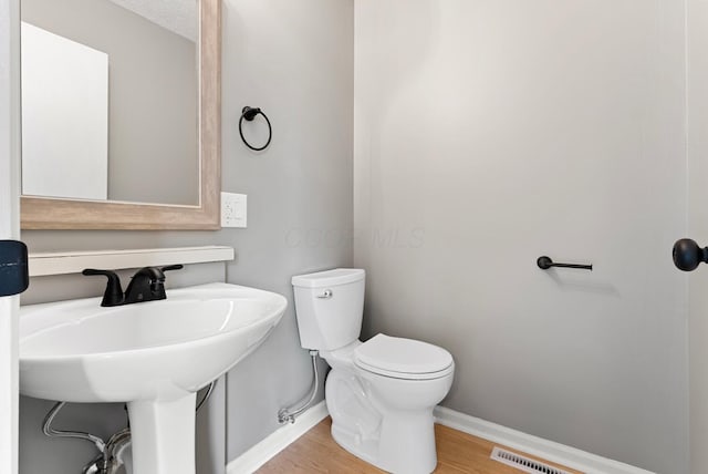 121 Granville St, Pataskala, OH 43062 - bathroom with toilet, visible vents, baseboards, and wood finished floors
