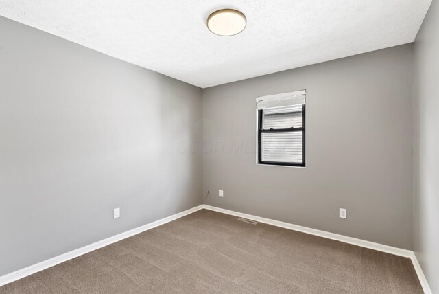 121 Granville St, Pataskala, OH 43062 - carpeted spare room featuring visible vents, baseboards, and a textured ceiling