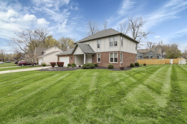 view of front of property featuring a garage, a front yard, fence, and brick siding
