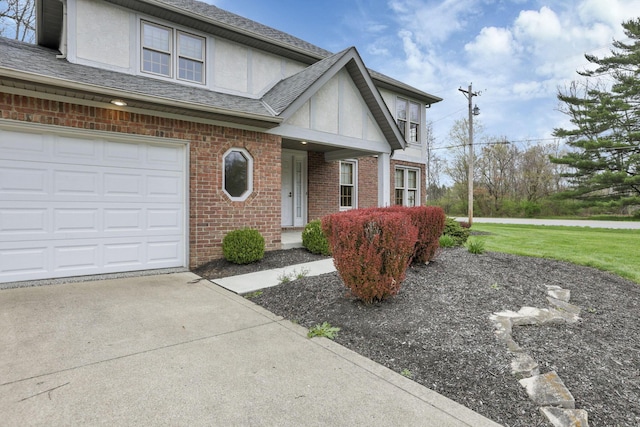 view of front of house with brick siding, roof with shingles, driveway, and stucco siding