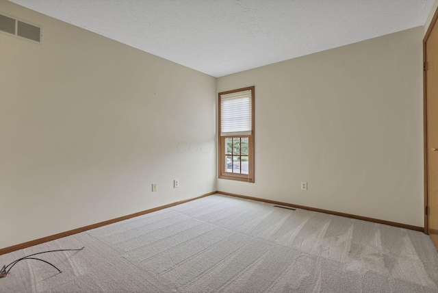 unfurnished room with light carpet, baseboards, and visible vents