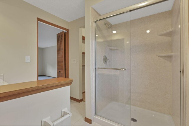 bathroom featuring a shower stall and tile patterned floors