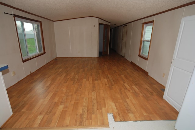 20543 Treaty Line Rd, West Mansfield, OH 43358 - spare room featuring light wood-style floors, a textured ceiling, and ornamental molding