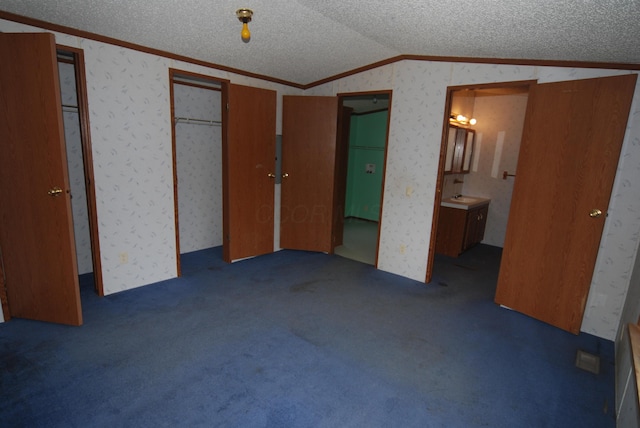 20543 Treaty Line Rd, West Mansfield, OH 43358 - unfurnished bedroom featuring a textured ceiling, wallpapered walls, ornamental molding, and vaulted ceiling
