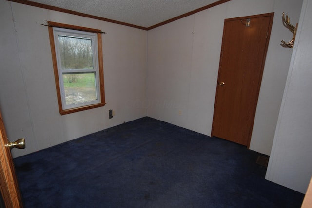 20543 Treaty Line Rd, West Mansfield, OH 43358 - unfurnished room featuring a textured ceiling, dark colored carpet, and ornamental molding