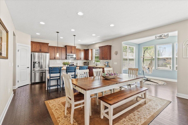 dining area featuring baseboards, recessed lighting, a textured ceiling, and dark wood-style floors