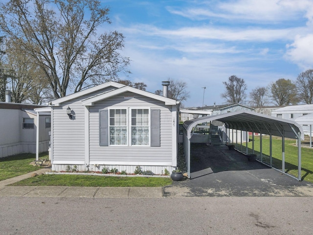 2445 Columbus Lancaster Rd NW Unit 147, Lancaster, OH 43130 - view of front of house with a carport, a front yard, and aphalt driveway