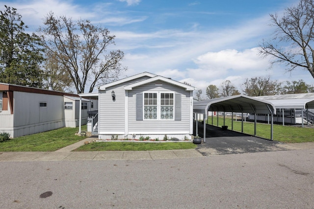 2445 Columbus Lancaster Rd NW Unit 147, Lancaster, OH 43130 - manufactured / mobile home featuring a carport, driveway, and a front yard
