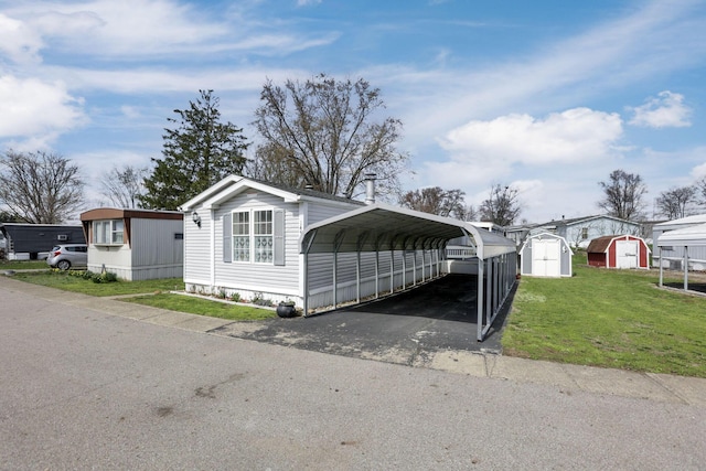 2445 Columbus Lancaster Rd NW Unit 147, Lancaster, OH 43130 - view of front of property with a shed, a detached carport, an outdoor structure, a front lawn, and driveway