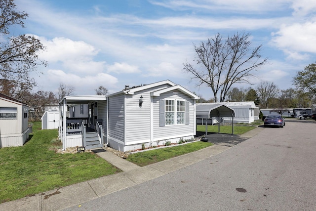 2445 Columbus Lancaster Rd NW Unit 147, Lancaster, OH 43130 - manufactured / mobile home with a carport, a storage shed, an outbuilding, and a front yard