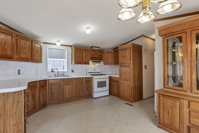 2445 Columbus Lancaster Rd NW Unit 147, Lancaster, OH 43130 - kitchen featuring tasteful backsplash, vaulted ceiling, white range with gas cooktop, under cabinet range hood, and a sink