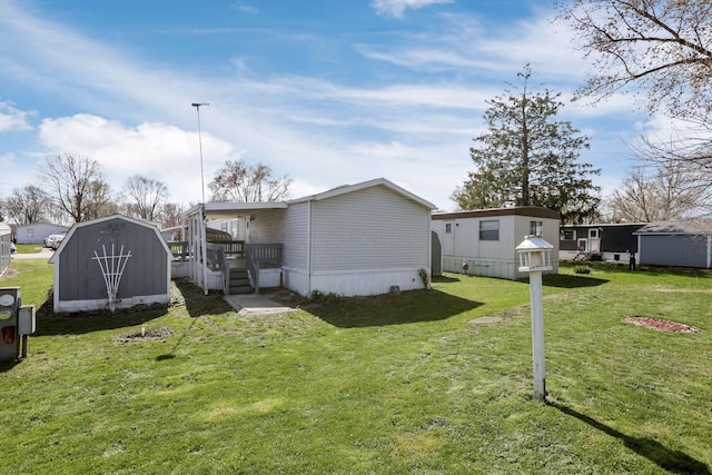 2445 Columbus Lancaster Rd NW Unit 147, Lancaster, OH 43130 - rear view of house featuring a yard, a storage shed, and an outbuilding