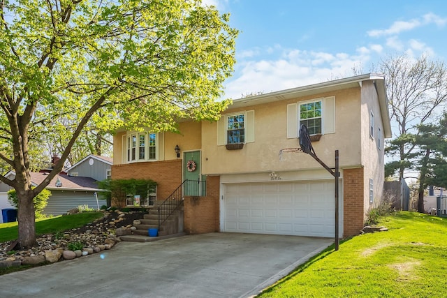 raised ranch featuring stucco siding, an attached garage, brick siding, and concrete driveway