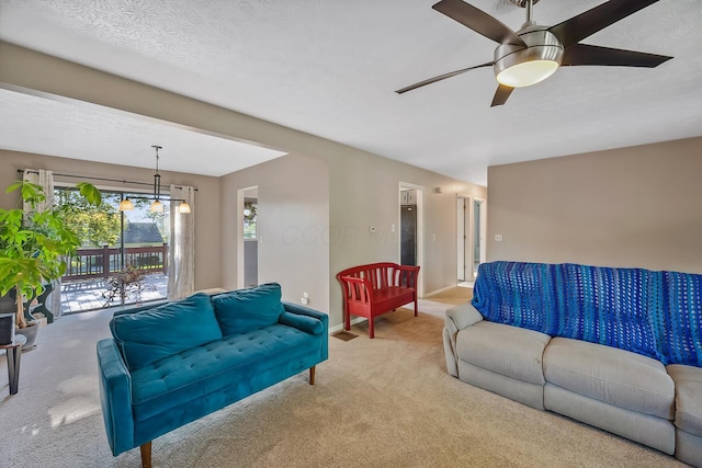 living room with a ceiling fan, baseboards, and carpet floors
