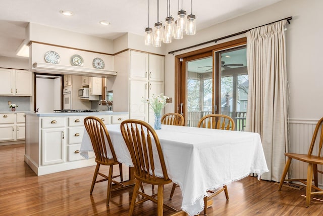 dining room featuring wood finished floors and recessed lighting
