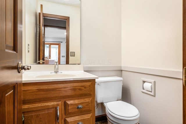 bathroom with toilet and vanity