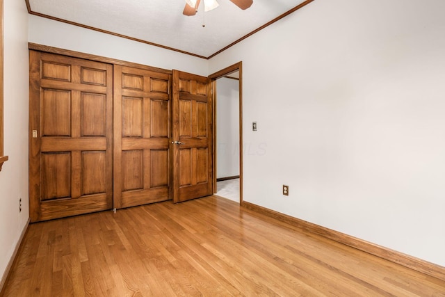 unfurnished bedroom featuring light wood-style floors, baseboards, ornamental molding, and ceiling fan