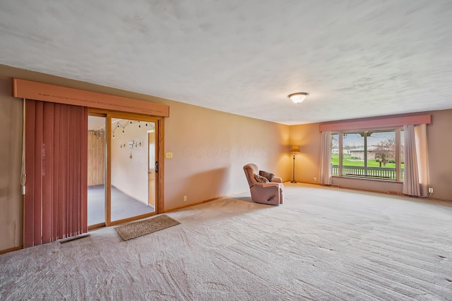 unfurnished room featuring visible vents, baseboards, and carpet